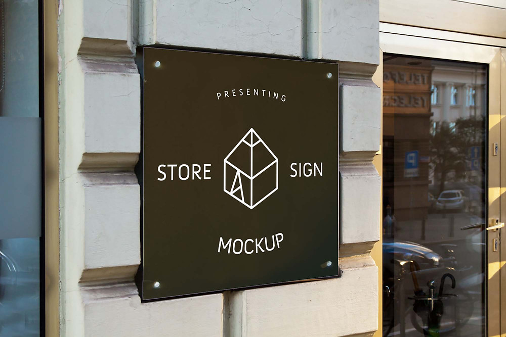 Mockup of a mupi placed on an elegant boutique window. Free Store Signs Mock Up Psd